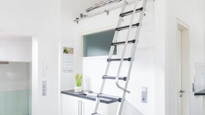 A kitchen with a white countertop, a white door, and a white wall. - Lively Apartment in Norderney (Norderney)