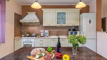 Villa | Private kitchen | Oven, electric kettle, toaster