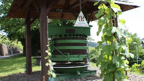 A wooden pavilion with a green structure labeled "Patenschaft Klosterberg - Kelter" and the year "1998" on the roof. - The Moselle Gate to Koblenz (Lehmen)