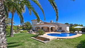 A house with a swimming pool, surrounded by a well-maintained lawn and palm trees. - Esperanza - Javea, Costa Blanca (Javea)