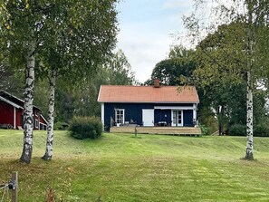 A single-story house with a red-tiled roof, a porch, and a small front yard. - 4 Star Holiday Home in Tronodal (Trönödal)