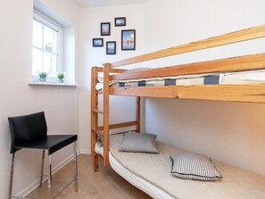 A bunk bed with a ladder, a desk, and a chair in a room with a window and wall-mounted pictures. - 5 Person Holiday Park Home in Bogense (Bogense)