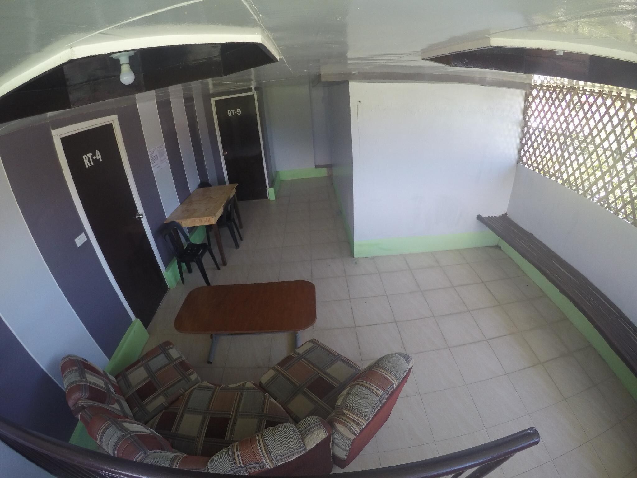 A room with a sofa set, a small table, and two doors labeled RT-4 and RT-5.