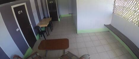A room with a sofa set, a small table, and two doors labeled RT-4 and RT-5.