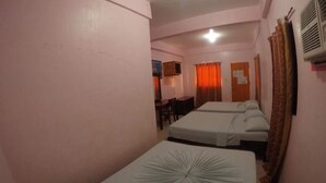 A room with two beds, a desk, and a chair. - Buena Lynne White Beach Puerto Galera (Puerto Galera)