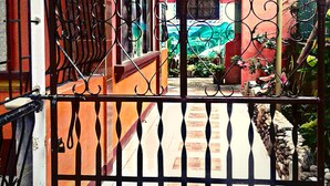 A gated entrance with a staircase leading to a colorful interior. - Buena Lynne White Beach Puerto Galera (Puerto Galera)