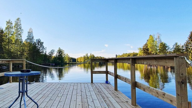 A wooden dock extending over calm water with a clear sky above. - 4 Person Holiday Home in Karlskoga (Karlskoga)