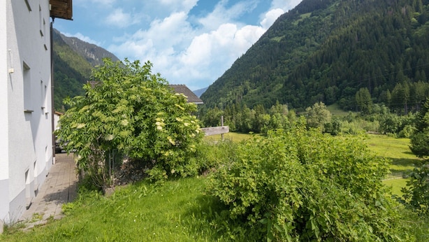 A mountain landscape with a building on the left.