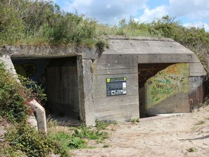 Ein Betongebäude mit Graffiti und einem Schild, das Bunkers und Schlafgelegenheiten anzeigt.