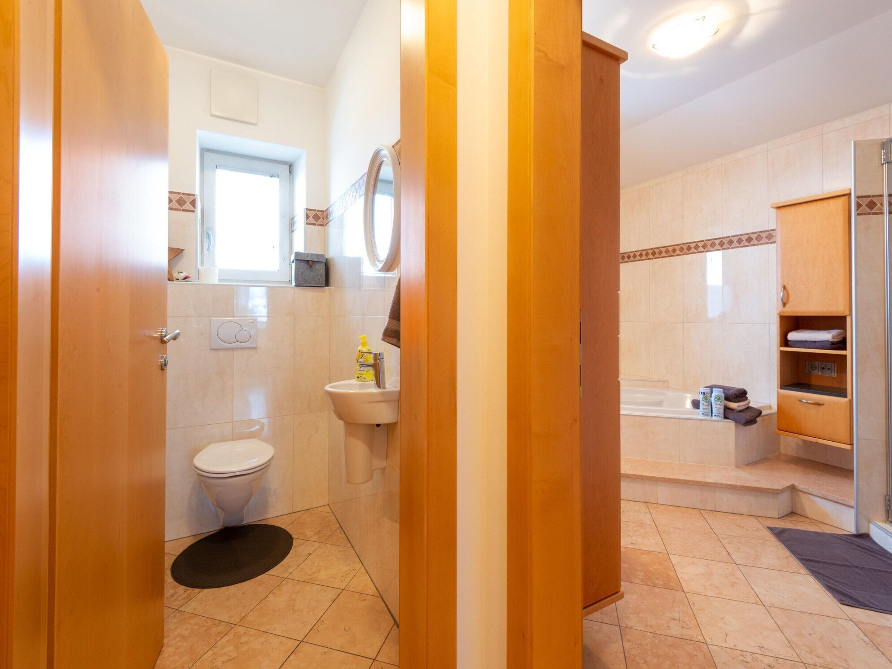 A bathroom with a toilet, sink, and shower area.