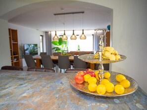 A dining area with a table set for two, featuring a fruit platter and a decorative centerpiece. - am Wehr Comfortable Holiday Residence (Allersberg)