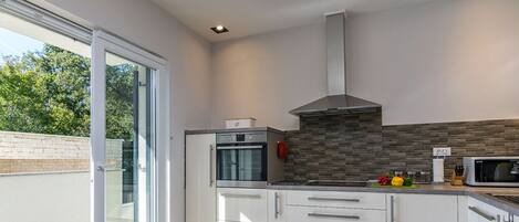 Villa | Private kitchen | Oven, electric kettle, toaster