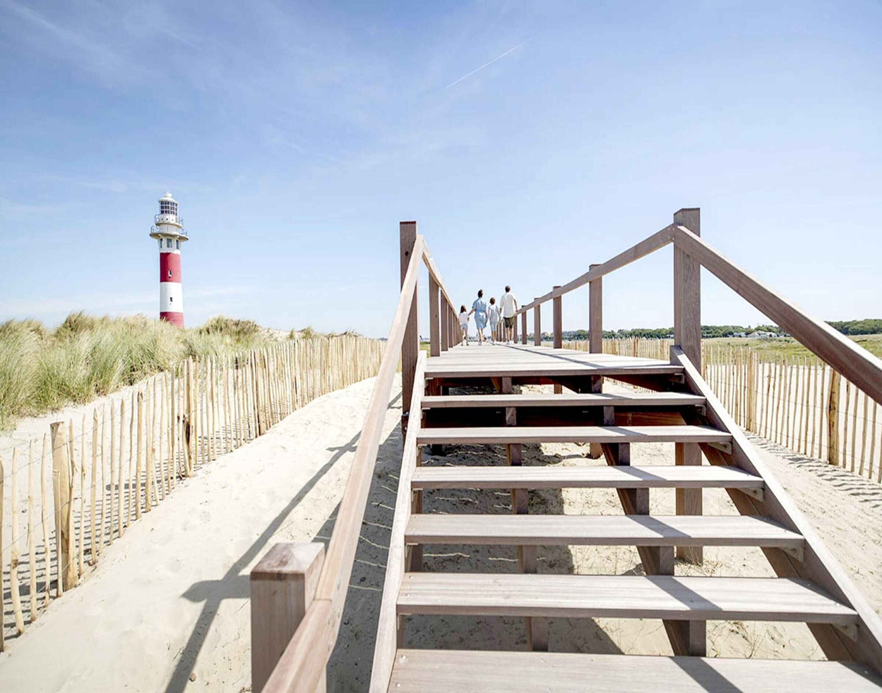 Una passerella di legno che conduce a un faro.