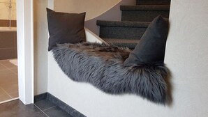 A staircase with a fur-lined wall and two dark pillows. - Holiday Home Naturally Good (Voehl)