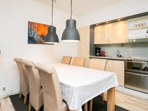 A modern kitchen with a dining area. - 4 Person Holiday Park Home in Faaborg (Faaborg)