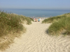 A sandy beach path leading to the sea with dunes on either side. - Holiday Home in Kamperland Near Lake (Kamperland)