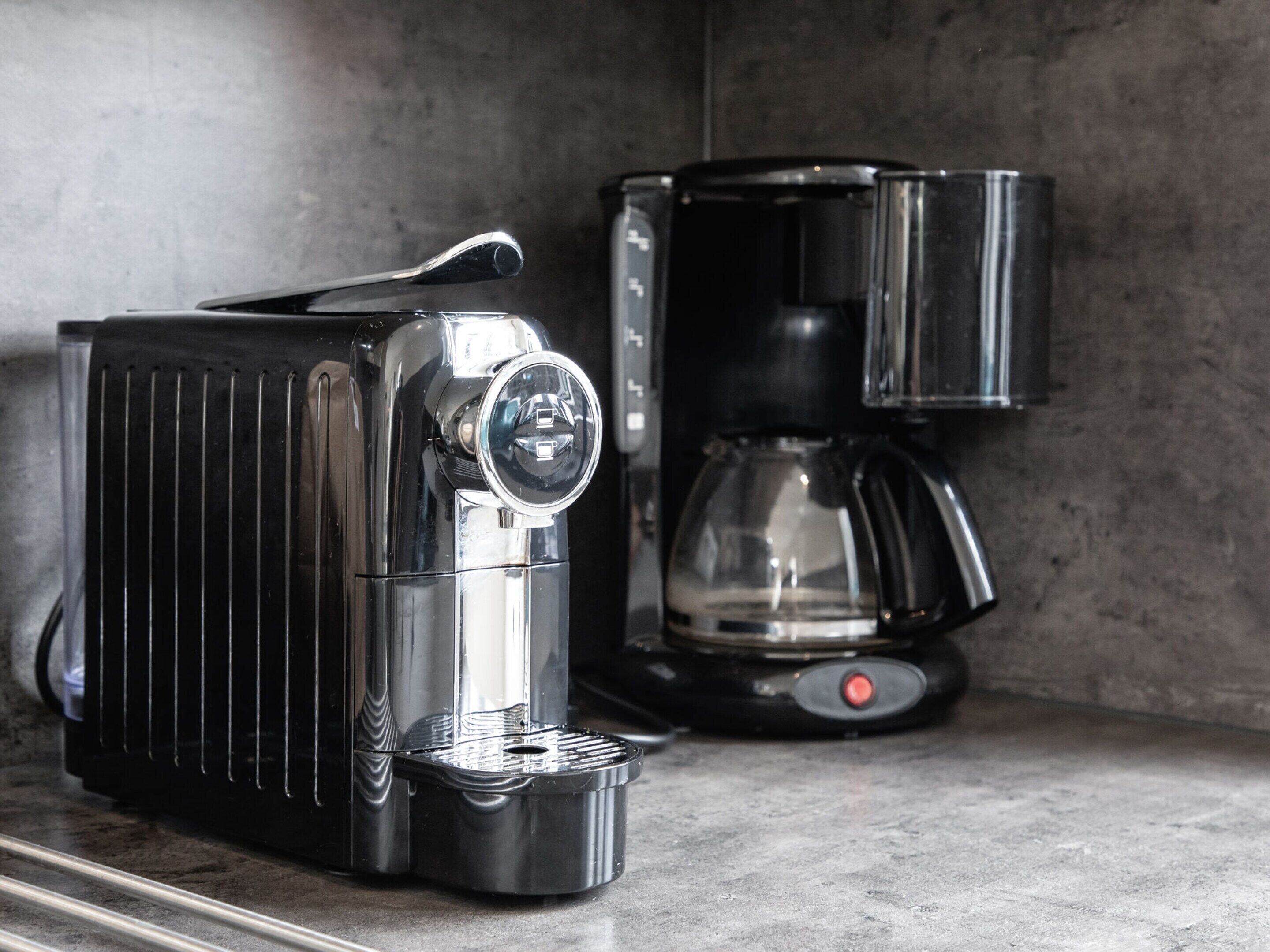 A kitchen with a toaster and a coffee maker on the counter.
