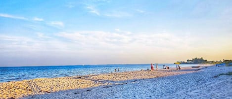 A beach with a clear sky and calm sea.