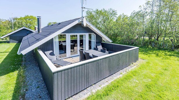 A modern outdoor deck with a sloped roof, built-in seating, and a satellite dish. - 4 Person Holiday Home in Hemmet (Hemmet)