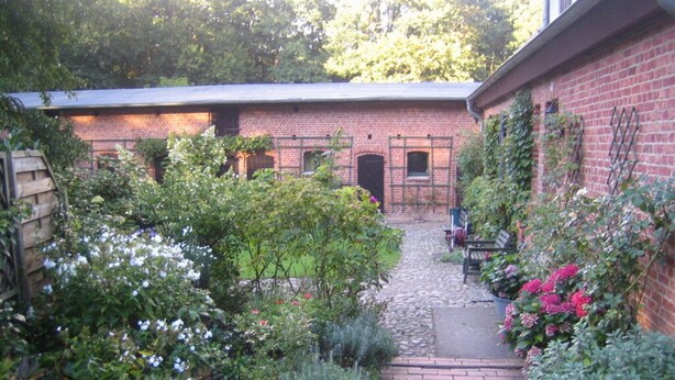 A brick building with a garden path leading to a door. - Old Zerwelin Forestry Company (Nordwestuckermark)