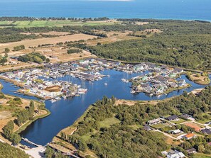 An aerial view of a marina with boats docked, surrounded by residential buildings and greenery. - Holiday Home on a Holiday Park in Ebeltoft (Ebeltoft)