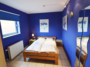 A bedroom with a wooden bed, a nightstand, a lamp, and a window. - Sourbrodt Villa With Pool (Waimes)