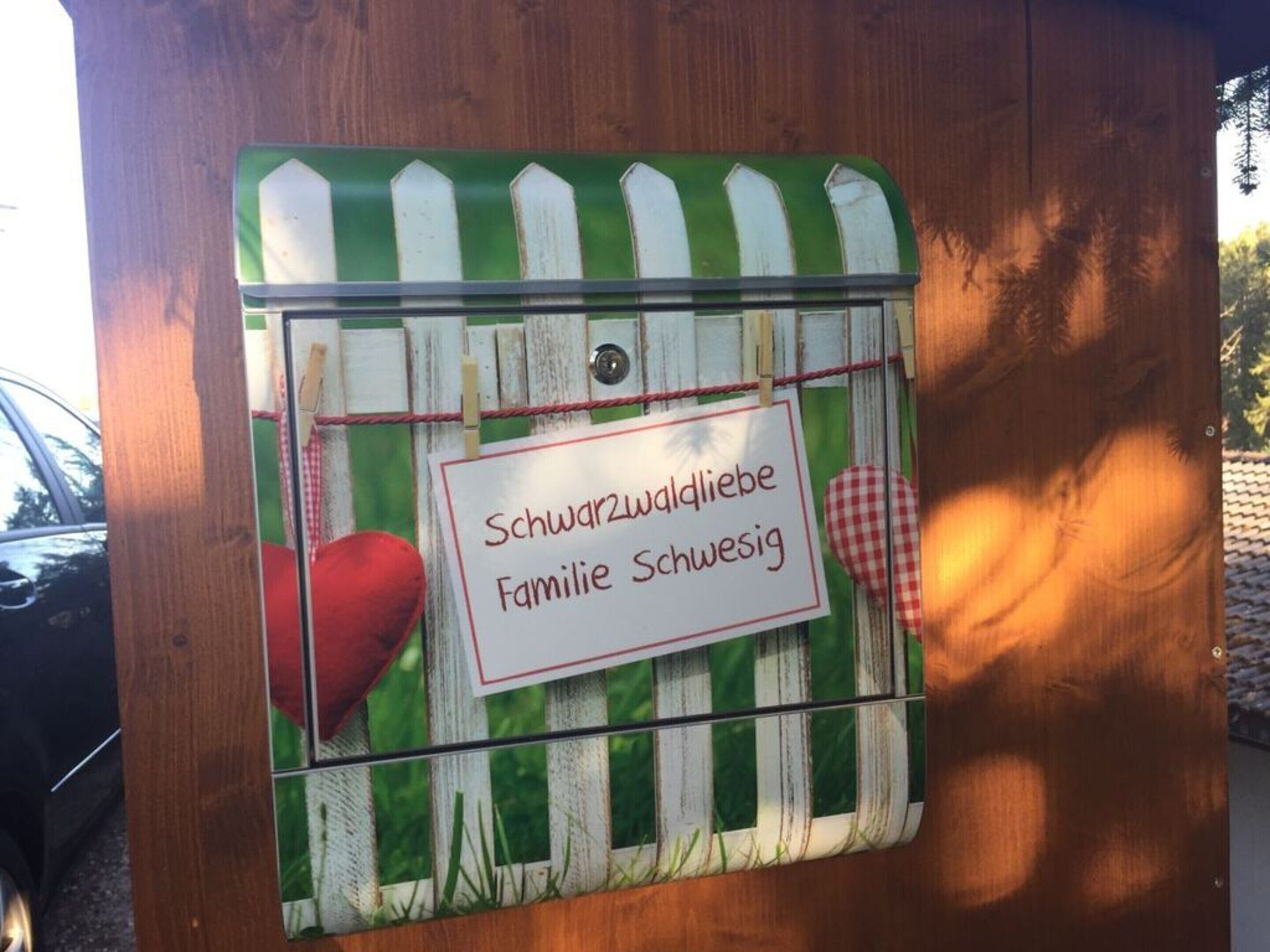 A wooden structure with a sign that reads "Schwarzwaldliebe Familie Schwesig".