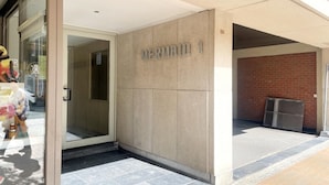 A building entrance with a glass door, a sign reading "MERMAID 1", and a tiled floor. - Apartment in Nieuwpoort With sea Views (Nieuwpoort)
