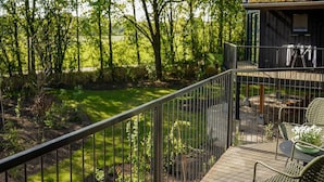 A balcony with a view of a green landscape and trees. - Spacious Holiday Home With Garden (Wekerom)