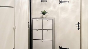 A white storage unit with multiple drawers and a small potted plant on top. - 5 Person Holiday Home in Idre (Idre)