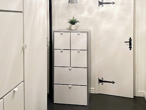 A white storage unit with multiple drawers and a small potted plant on top. - 5 Person Holiday Home in Idre (Idre)