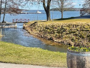 A riverside park with a wooden bridge, grassy areas, and a water body. - 6 Person Holiday Home in Mariefred-by Traum (Mariefred)