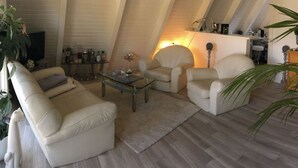 Un appartement-loft spacieux avec de hauts plafonds, un coin repas et une cuisine.