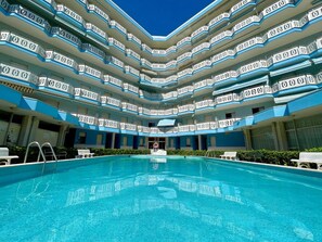 Guests can enjoy a central swimming pool surrounded by balconies with views of the surrounding area.