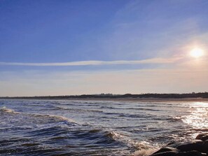 A beach with waves and a clear sky. - 6 Person Holiday Home in Albaek (Aalbaek)