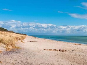 A beach with clear skies and calm waters. - 6 Person Holiday Home in Vaeggerlose (Vaeggerlose)