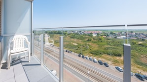 A balcony with a clear view of a highway and surrounding landscape. - Apartment With sun Facing Terrace (Middelkerke)