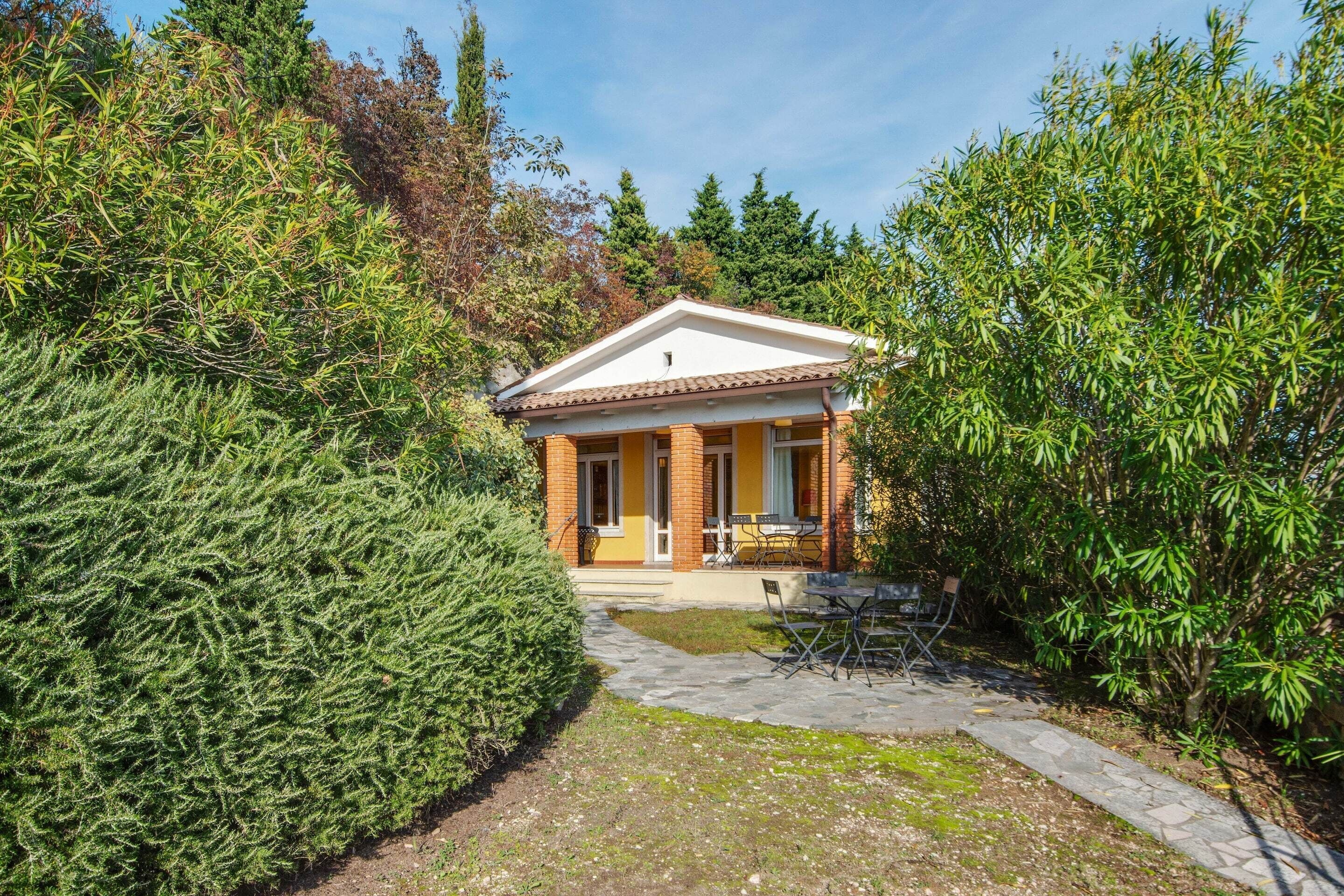 A house with a front porch, a stone pathway, and a small garden area.