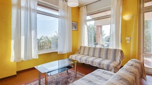 A room with a sofa, a glass coffee table, and a patterned rug. - Holiday Home in Marciaga With Pool & Gulf Views (Costermano sul Garda)