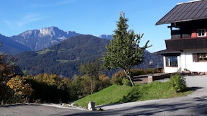 Une vue sur la montagne avec une maison dotée d’un toit en pente et d’un petit balcon.