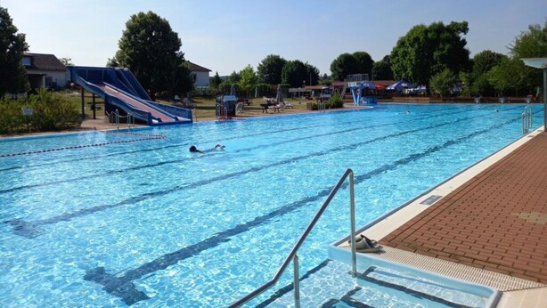 A swimming pool with lanes, a slide, and a lifeguard stand. - Haus Mariechen Comfortable Holiday Residence (Frielendorf)