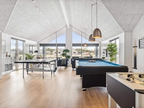 A spacious indoor area with a pool table, a billiards table, and a foosball table. - 5 Star Holiday Home in Norre Nebel (Norre Nebel)