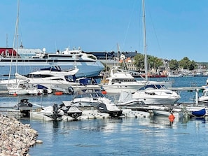A marina with various boats docked, including yachts and smaller vessels. - 5 Person Holiday Home in Valdemarsvik (Valdemarsvik)