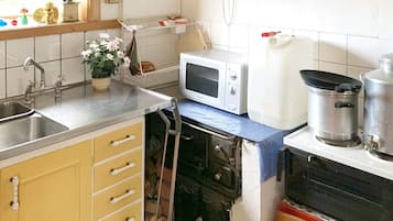 A kitchen with a microwave, a sink, and a stove.