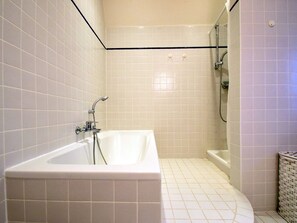 Ein Badezimmer mit Badewanne, Duschbereich und Toilette.