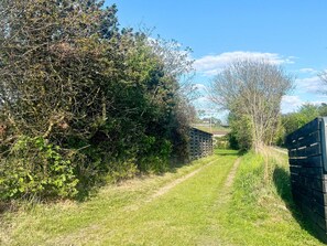 A rural pathway leading to a stone building. - 6 Person Holiday Home in Knebel (Knebel)