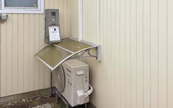 A room with a window, a heater, and a radiator.