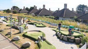 A miniature golf course with numbered holes, a pathway, and surrounding landscaping. - 5 Person Holiday Park Home in Karrebaeksminde (Karrebæksminde)