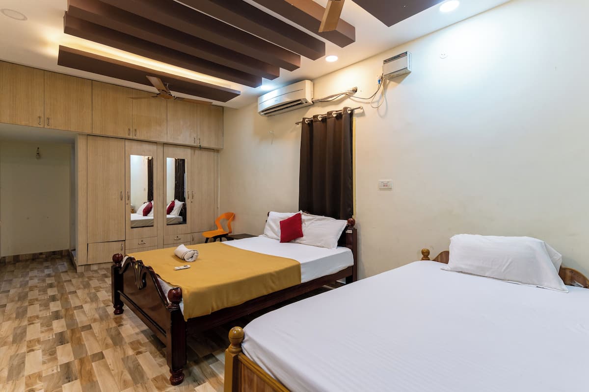 A hotel room with a wooden bed, a bedside table, a wardrobe, and a mirror.