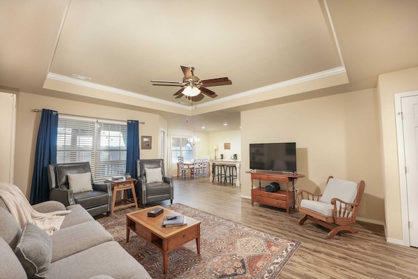 Relax in our cozy living room, featuring plush seating, a smart TV, and rustic touches.